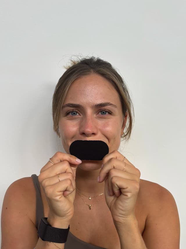 Woman holding mouth tape