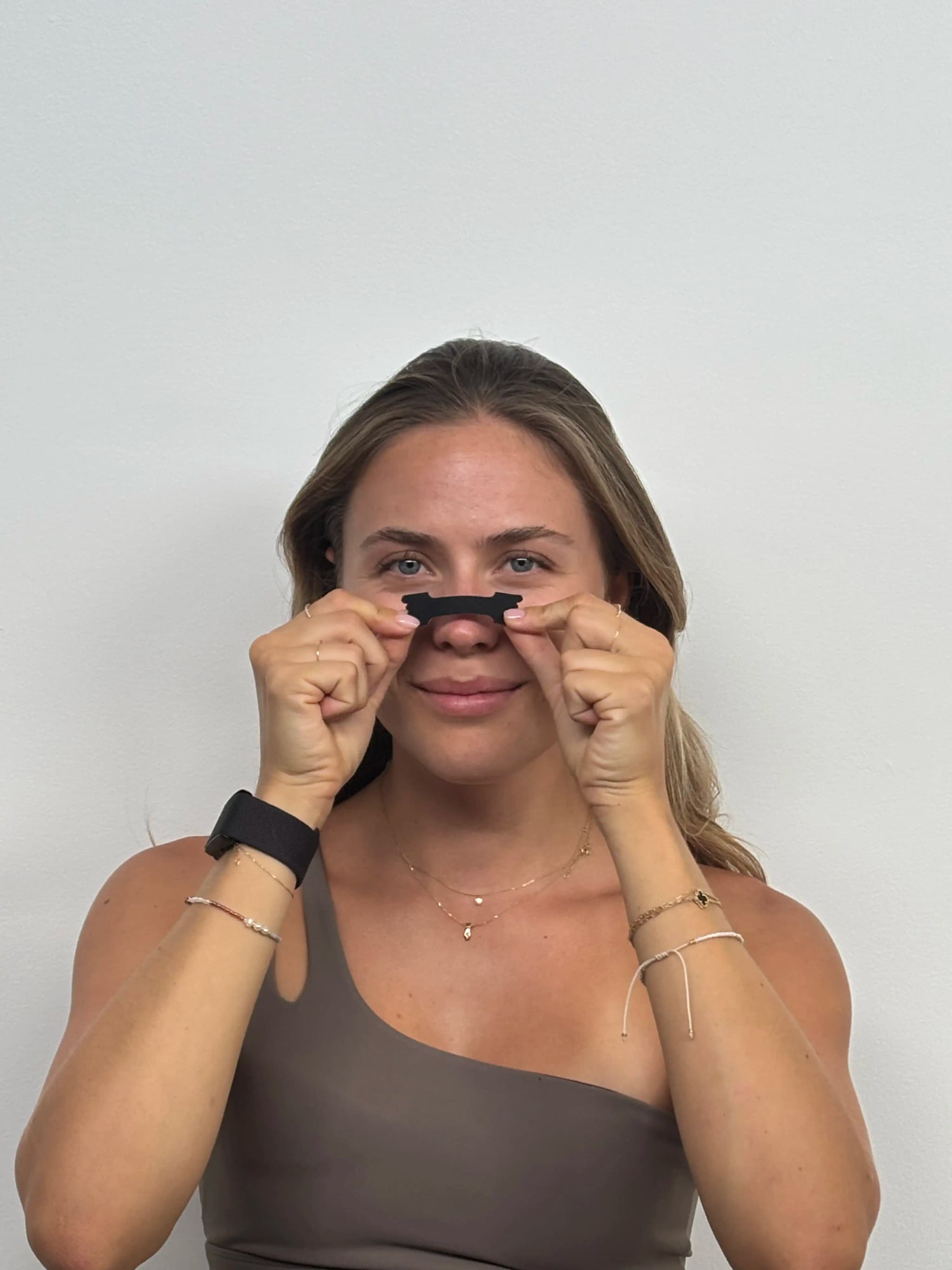 Woman holding nasal strips